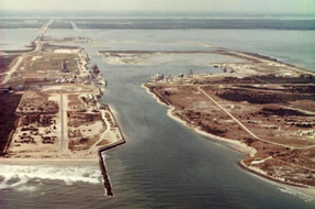 Aerial view showcasing the the ocean alongside the bustling Port, highlighting coastal beauty and activity.