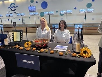 women behind a booth at a trade show